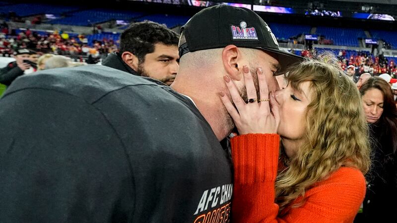 Taylor Swift kisses Kansas City Chiefs tight end Travis Kelce after an AFC Championship NFL...