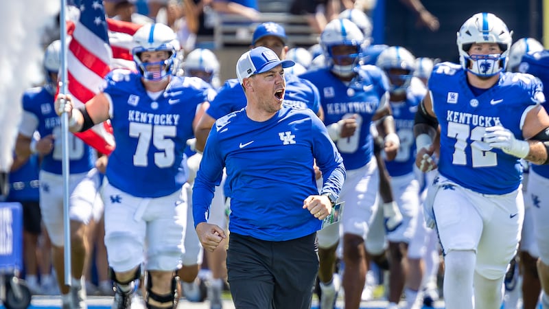 Kentucky coach Will Stein screams as he runs onto the field with his team before the Wildcats'...