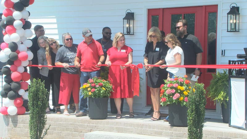 Organizers cut the ceremonial ribbon at the Logan, Butler and Simpson County Isaiah 117 House.