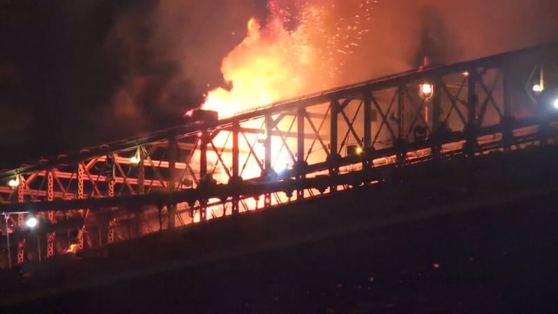 In this image taken from video, a fire breaks out on the Brooklyn Bridge in New York during...